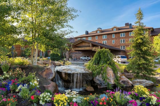 svr_lodge_exterior_summer_pond_flowers